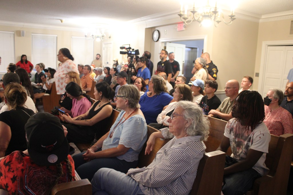 The packed Council Caucus Chamber, with Kenilworth resident Mary Savino is seated center right. Savino said she believes the council is working against the wishes of the community. Photo credit: Lucy Harper / NJ State House News Service