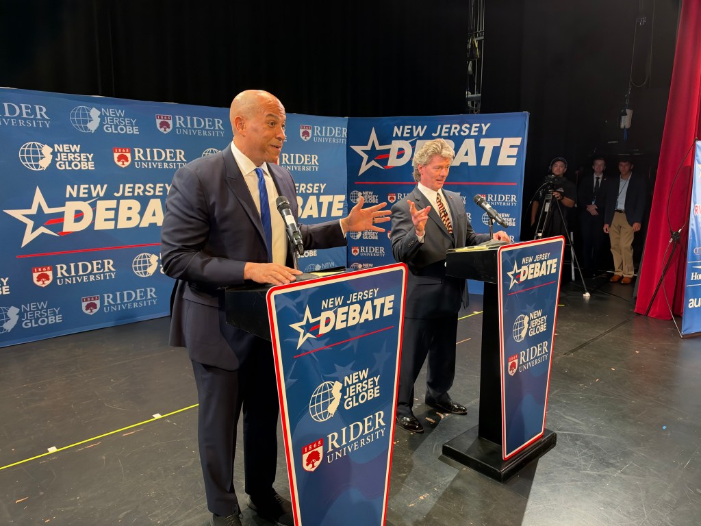 Incumbent Democratic Sen. Cory Booker and Republican Challenger Justin Murphy shake hands Thursday night at the start of their only debate before Election Day. Photo credit: Shohini Mitra/NJ State House News Service